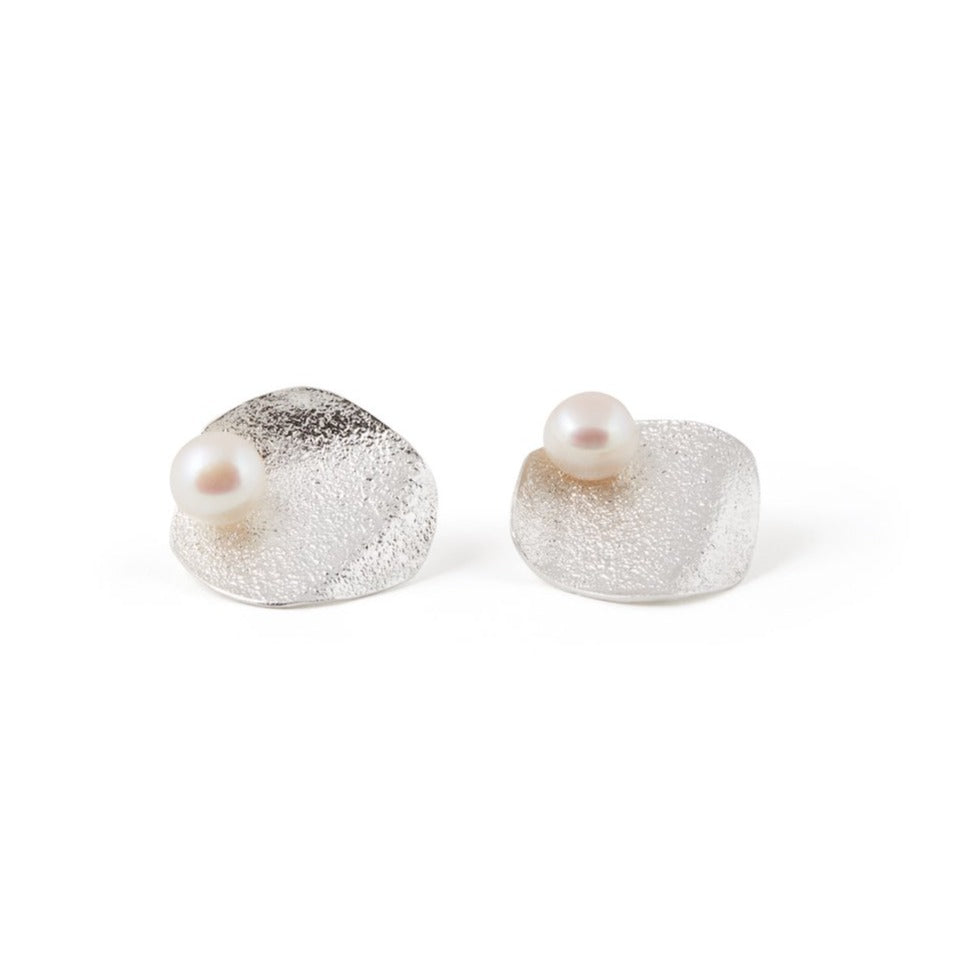 Boucles d'oreilles contemporaines avec une forme de pétale de fleur. Petite perle qui ajoute un look féminin. Elles sont délicates.